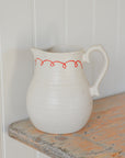 White Ceramic Jug with Red Bow