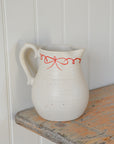 White Ceramic Jug with Red Bow