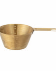 Brass coloured stainless steel measuring cup for cooking or baking designed by Bloomingville