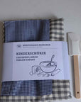 Redecker Children's Apron blue grey gingham with waist ties and a front pocket