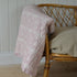 A floral paisley print quilt with a rose pattern, showing its soft texture and delicate design.