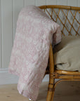 A floral paisley print quilt with a rose pattern, showing its soft texture and delicate design.