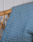 Light Blue Quilt With Cross Stitches