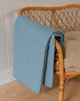 Light Blue Quilt With Cross Stitches