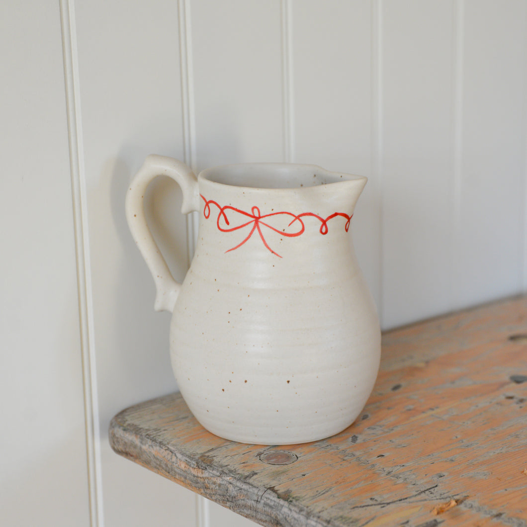 White Ceramic Jug with Red Bow