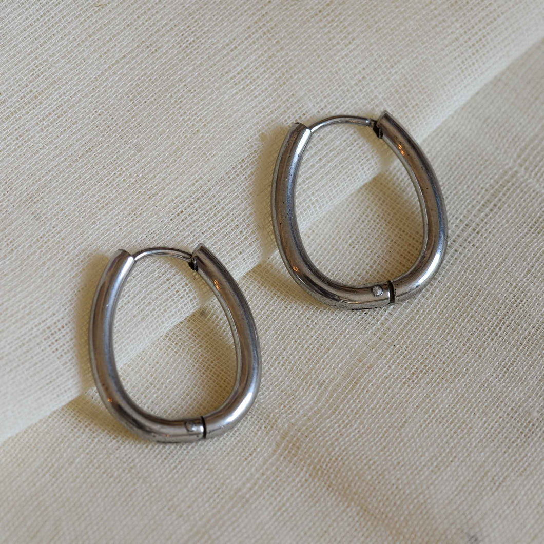 A weathered penny stainless steel silver luna hoop lock earrings