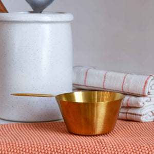Brass coloured stainless steel measuring cup for cooking or baking designed by Bloomingville 