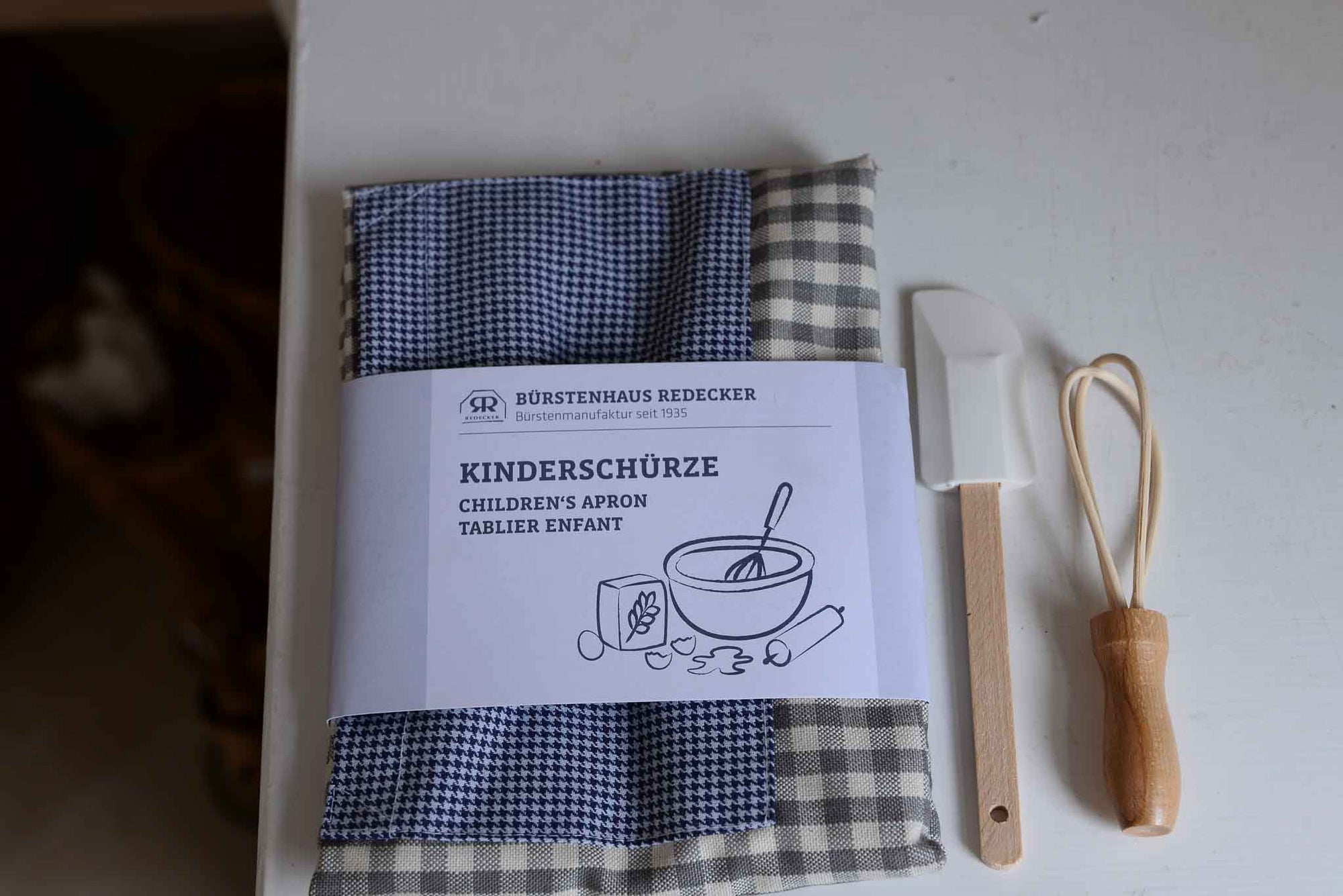 Redecker Children's Apron blue grey gingham with waist ties and a front pocket